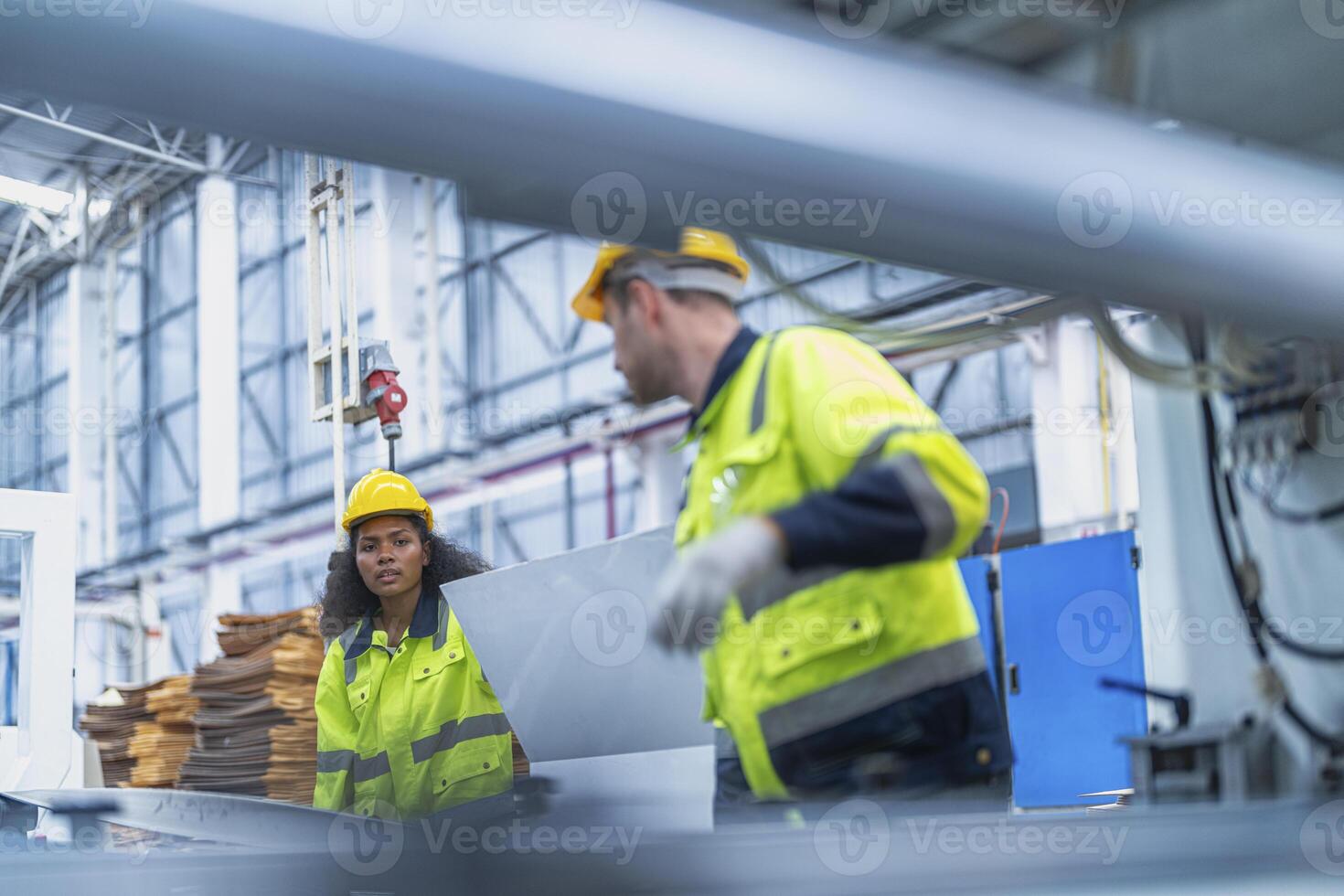 male and female technician engineers checking the process on Heavy machine. mechanical engineering team production. Industry manufacturing. Worker holding tablet and folde. High technology production. photo
