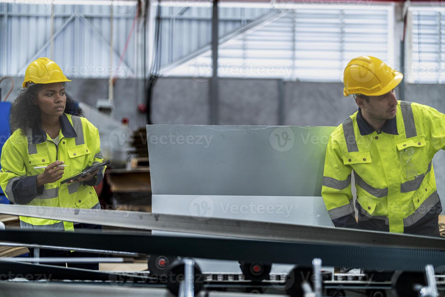 male and female technician engineers checking the process on Heavy machine. mechanical engineering team production. Industry manufacturing. Worker holding tablet and folde. High technology production. photo