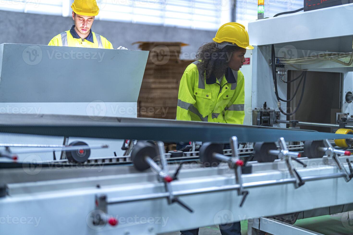 male and female technician engineers checking the process on Heavy machine. mechanical engineering team production. Industry manufacturing. Worker holding tablet and folde. High technology production. photo