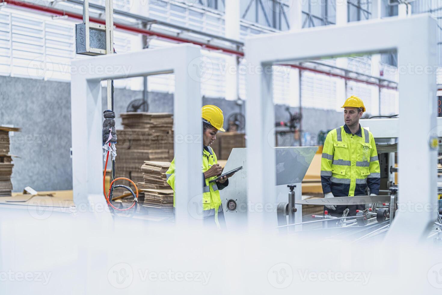 male and female technician engineers checking the process on Heavy machine. mechanical engineering team production. Industry manufacturing. Worker holding tablet and folde. High technology production. photo