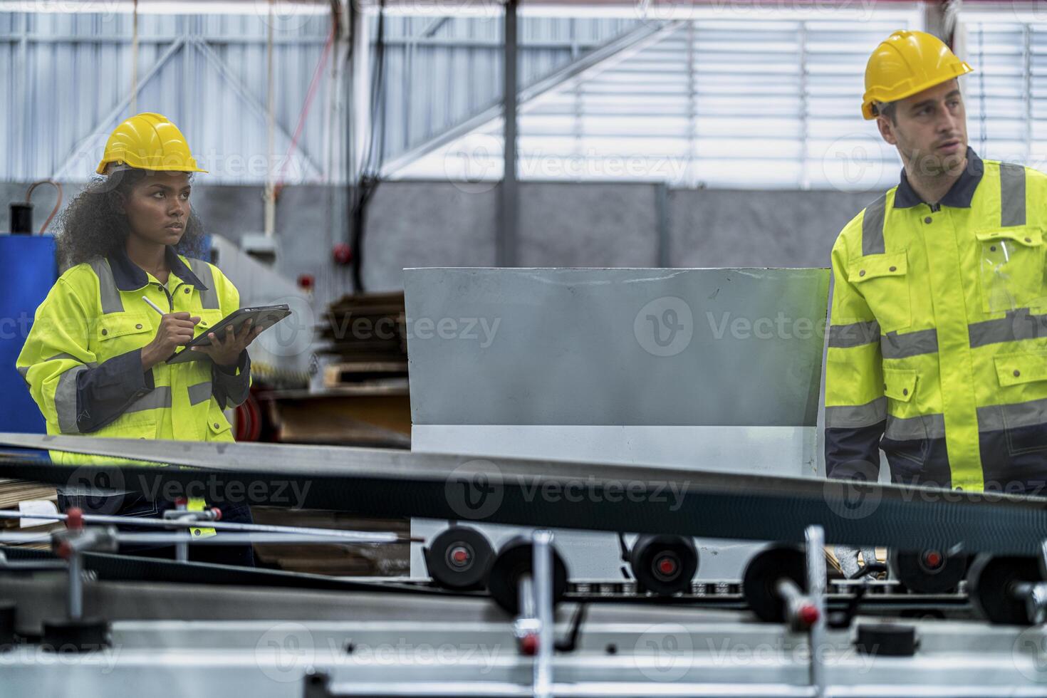 male and female technician engineers checking the process on Heavy machine. mechanical engineering team production. Industry manufacturing. Worker holding tablet and folde. High technology production. photo