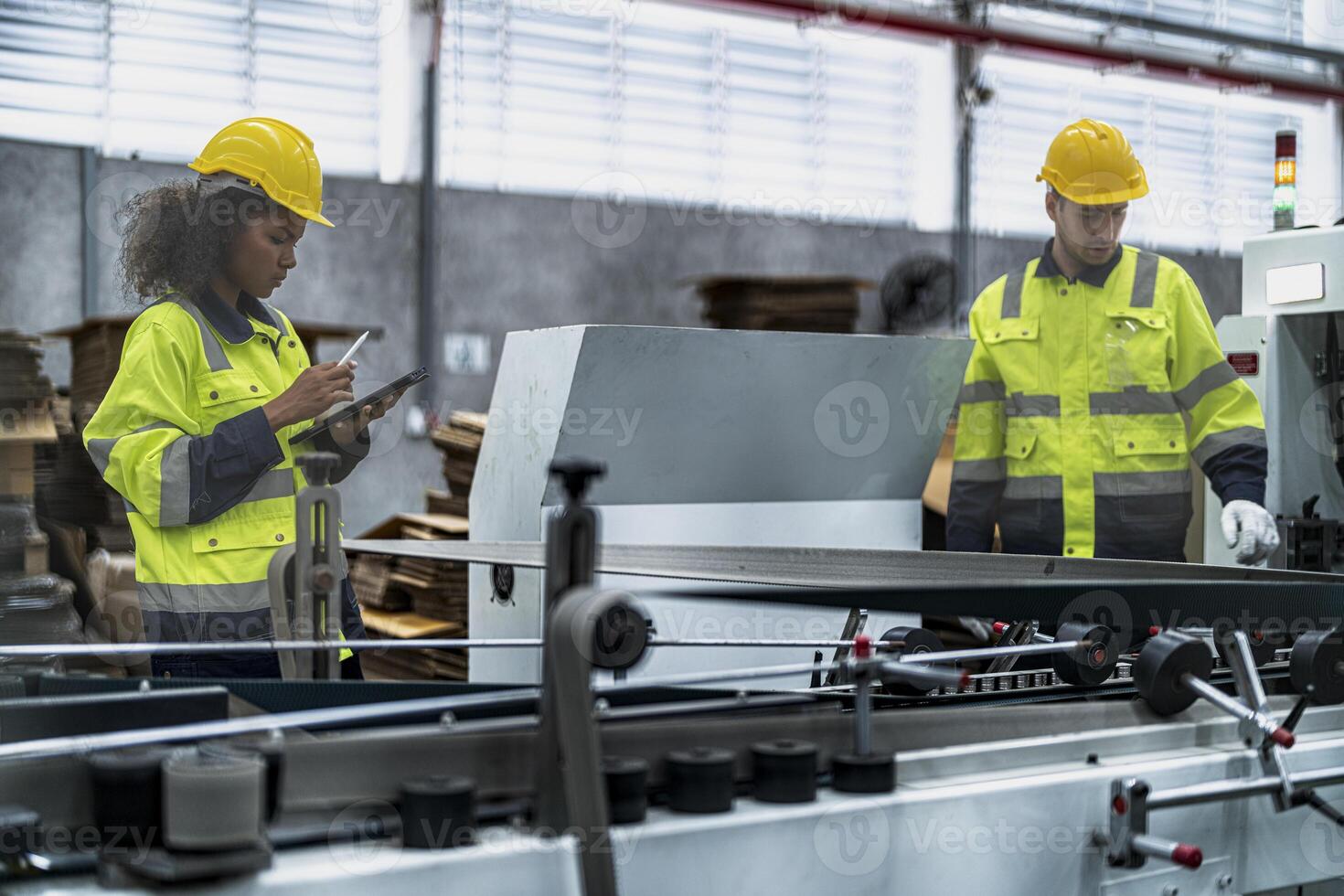 male and female technician engineers checking the process on Heavy machine. mechanical engineering team production. Industry manufacturing. Worker holding tablet and folde. High technology production. photo