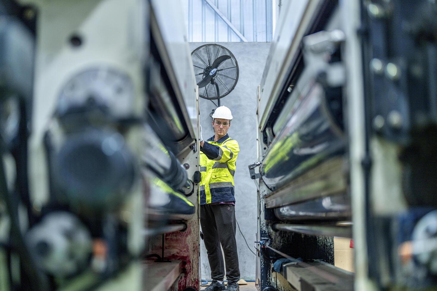 female engineers in neat work clothes prepare and control the production system of large modern machines in a factory producing industrial technology products. photo