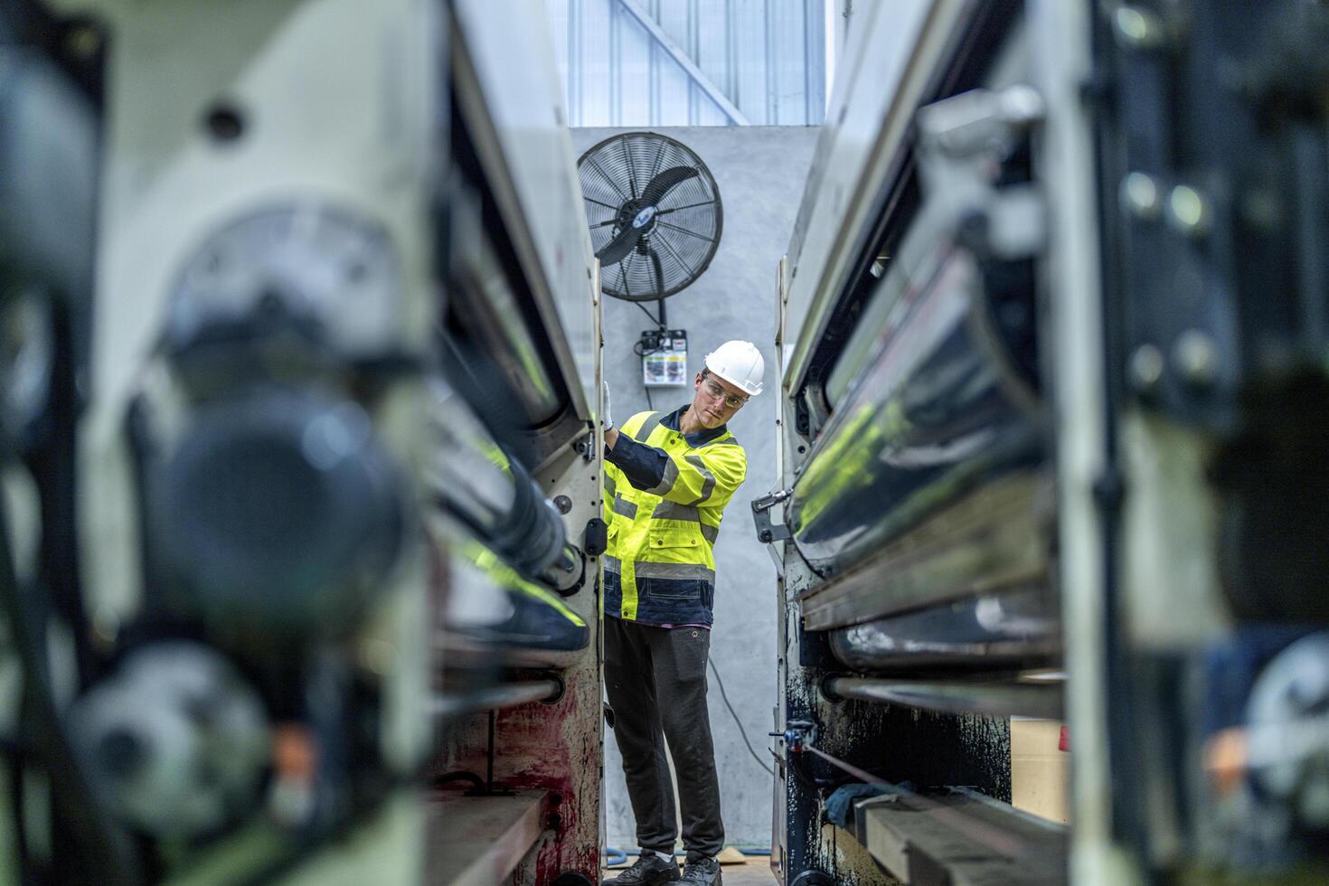 female engineers in neat work clothes prepare and control the production system of large modern machines in a factory producing industrial technology products. photo