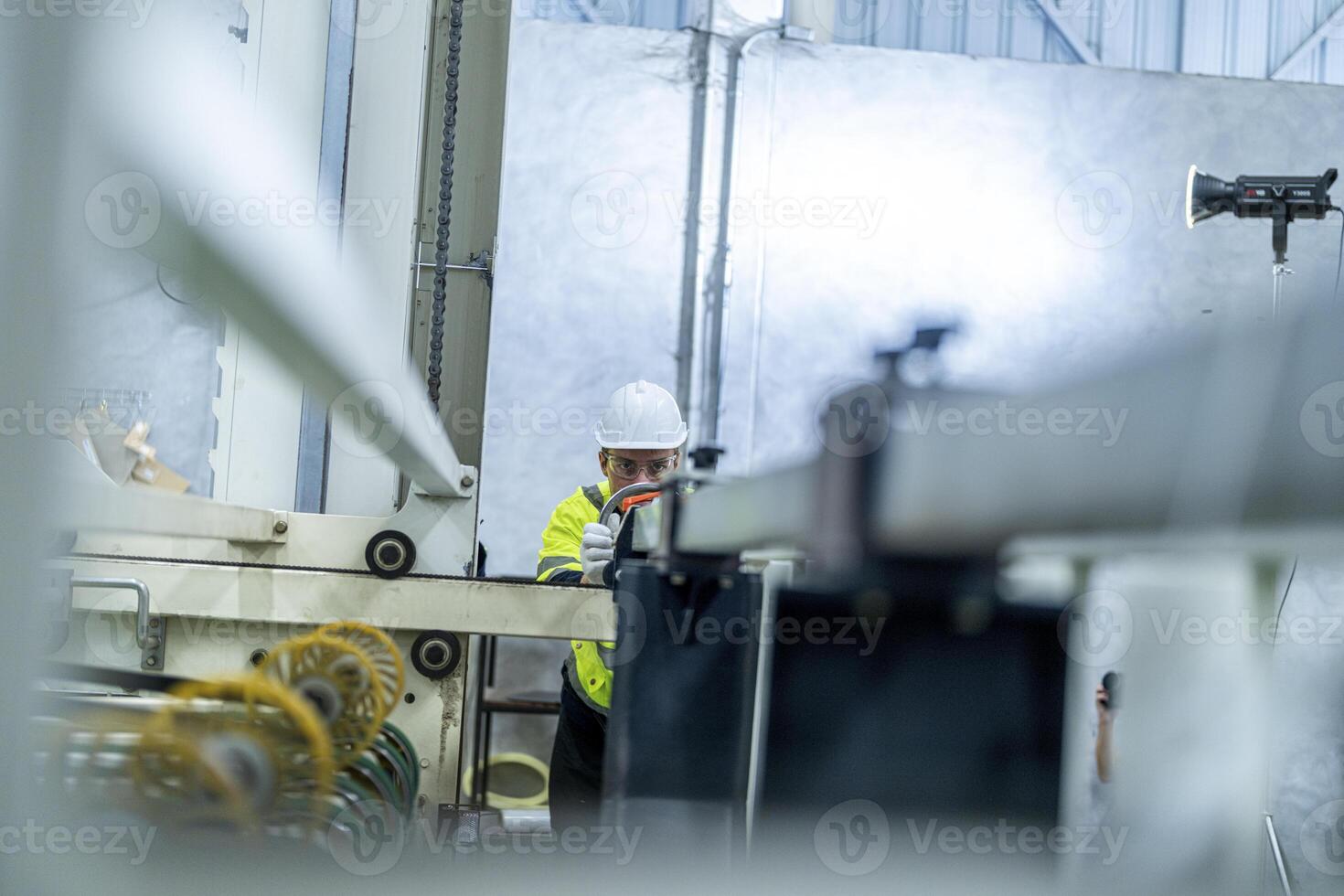 male engineers in neat work clothes prepare and control the production system of large modern machines in a factory producing industrial technology products. photo