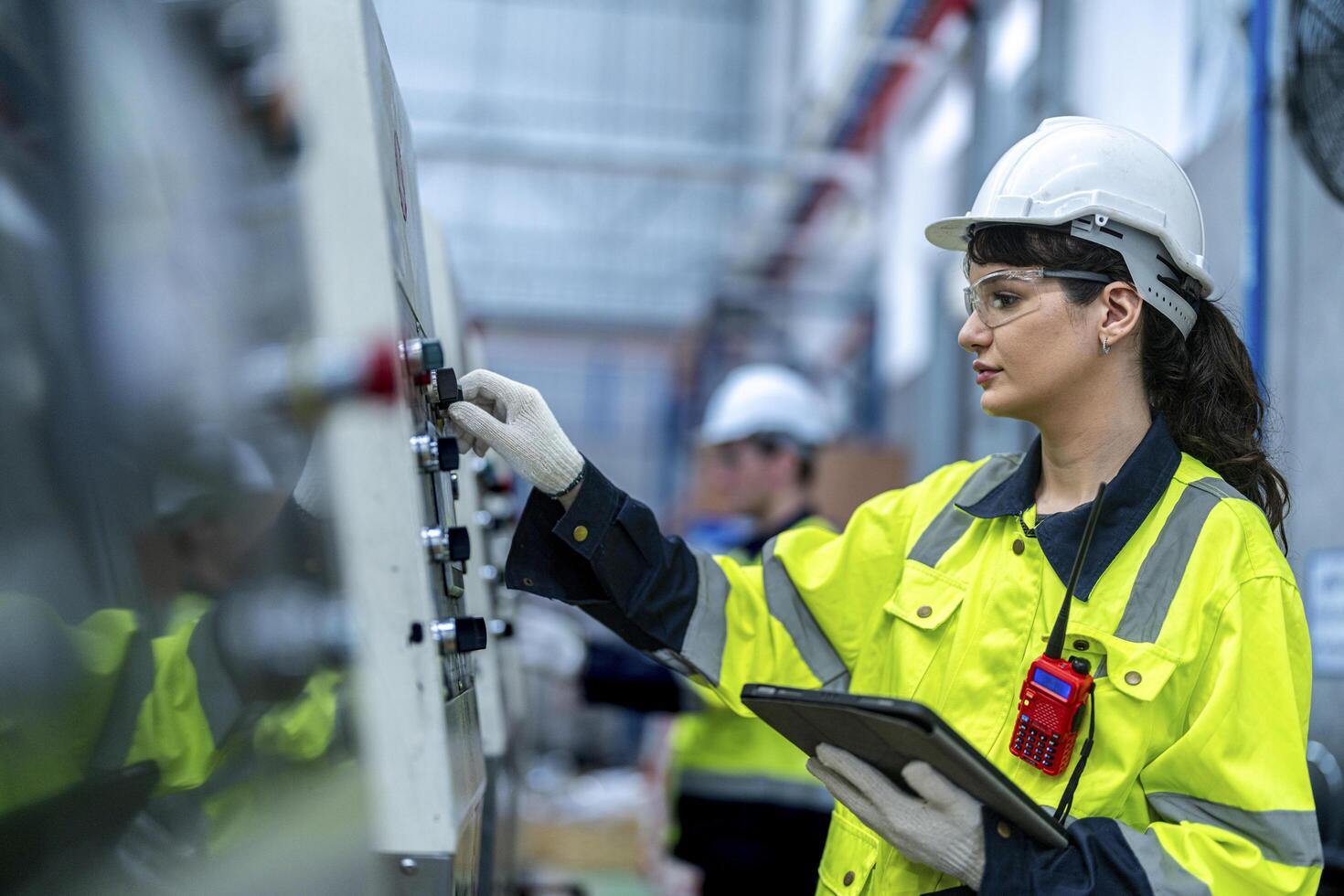 Male and female engineers in neat work clothes prepare and control the production system of large modern machines in a factory producing industrial technology products. photo