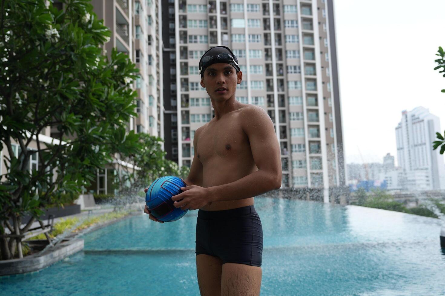 Asian men practicing swimming and preparing to play water polo and stretching and resting for water sports. photo