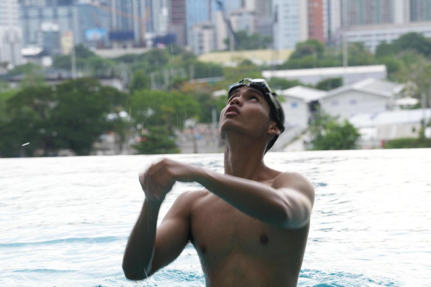 Asian men practicing swimming and preparing to play water polo and stretching and resting for water sports. photo