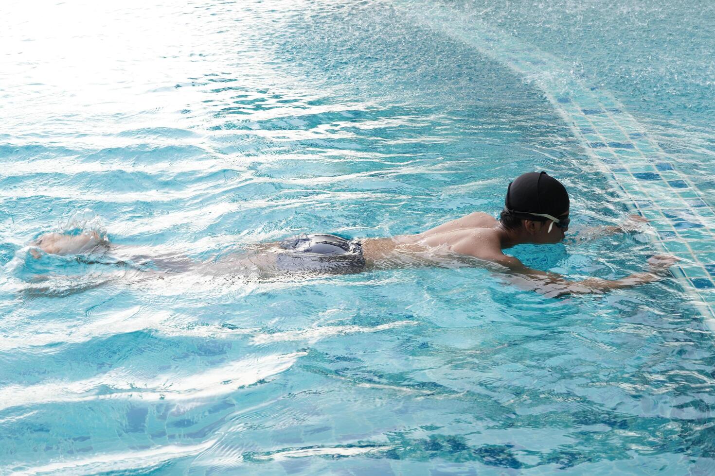 Asian men practicing swimming and preparing to play water polo and stretching and resting for water sports. photo