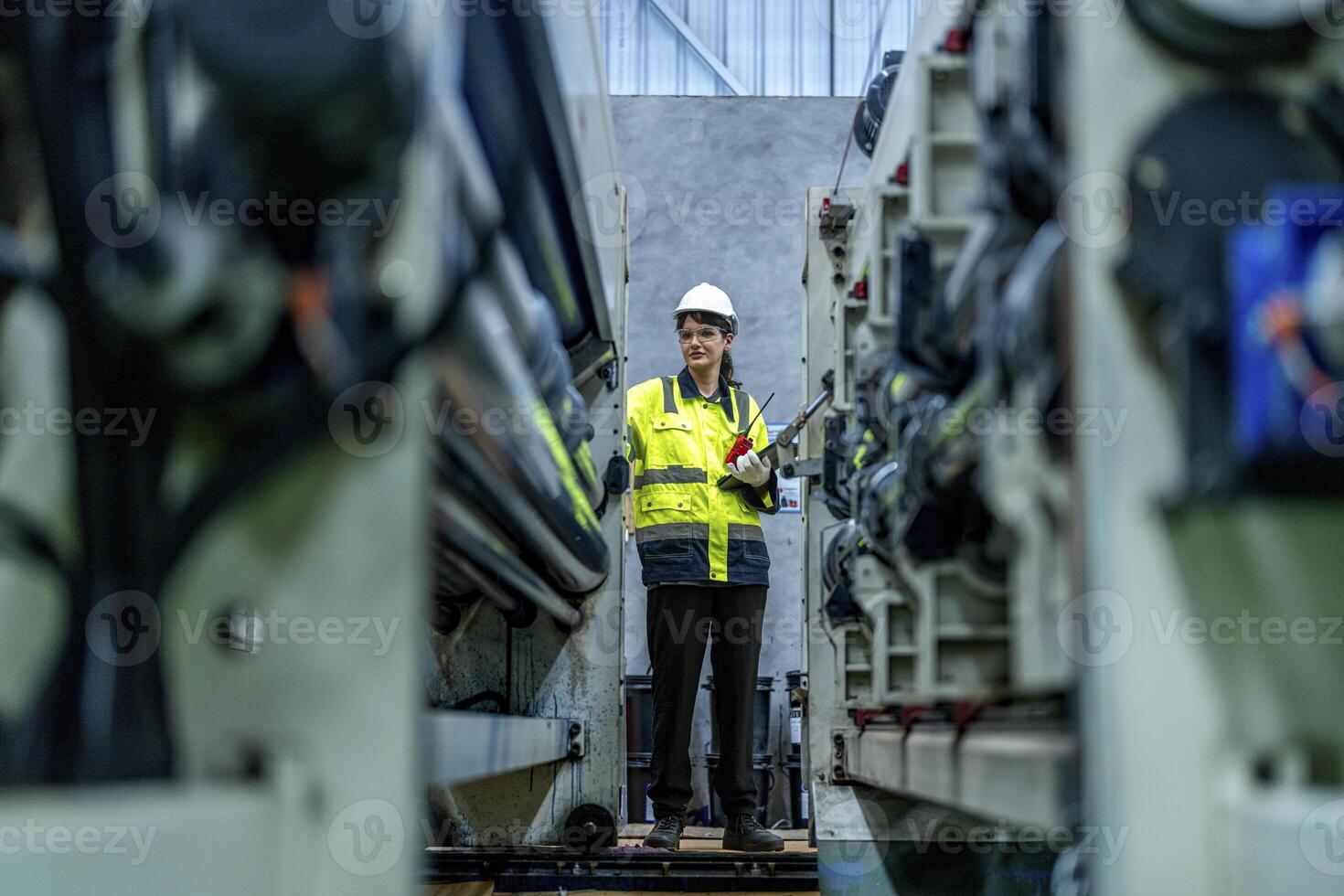 female engineers in neat work clothes prepare and control the production system of large modern machines in a factory producing industrial technology products. photo