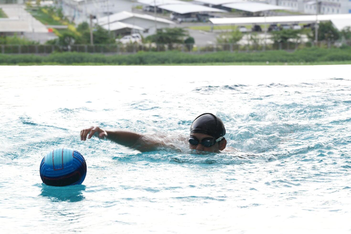 Asian men practicing swimming and preparing to play water polo and stretching and resting for water sports. photo
