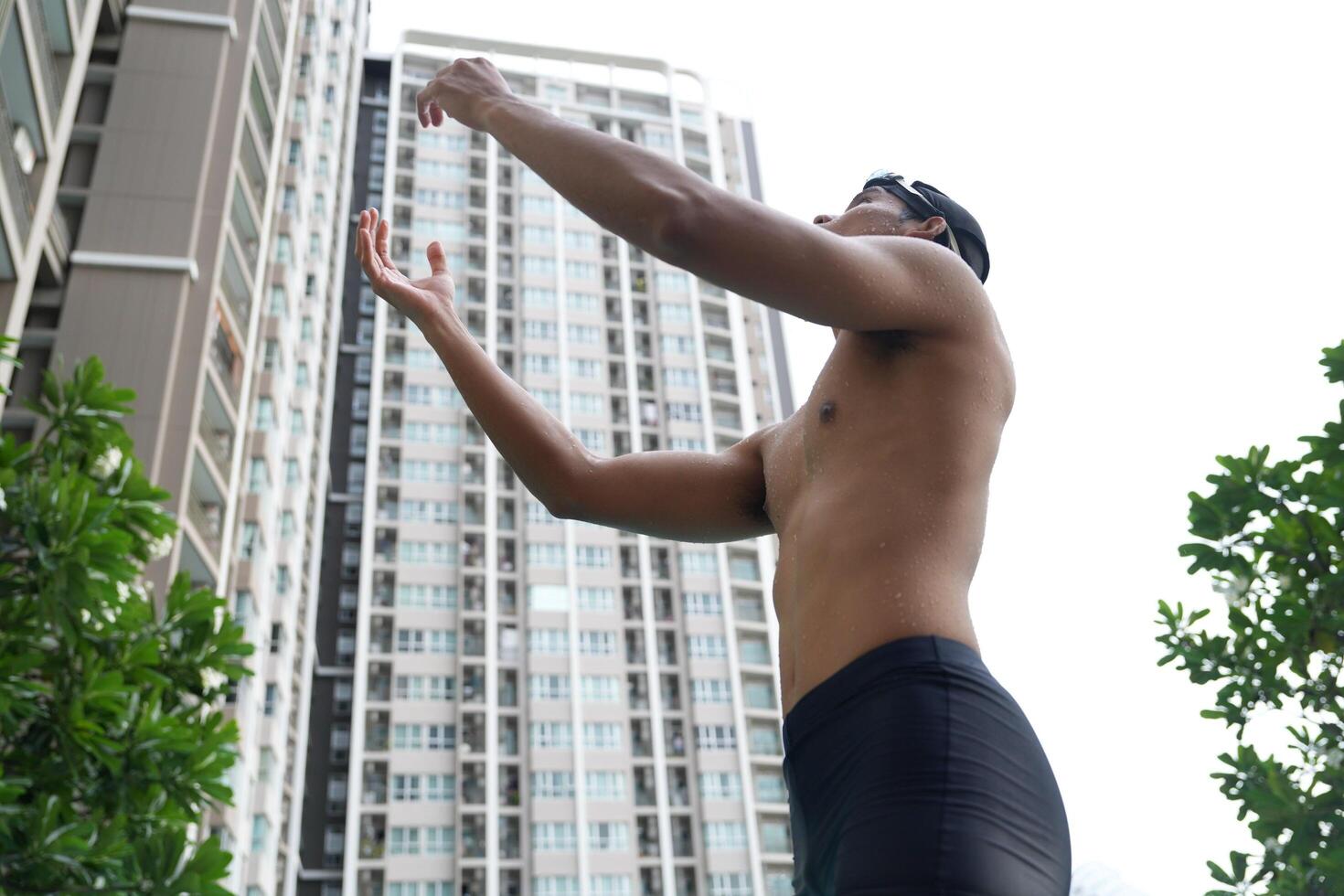 Asian men practicing swimming and preparing to play water polo and stretching and resting for water sports. photo