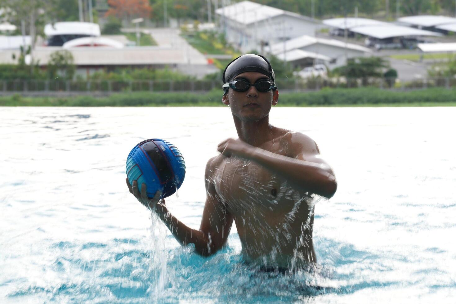 Asian men practicing swimming and preparing to play water polo and stretching and resting for water sports. photo
