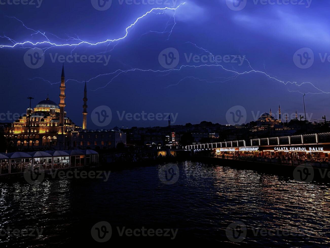 Istanbul Eminonu Mosque and lightning in the background photo