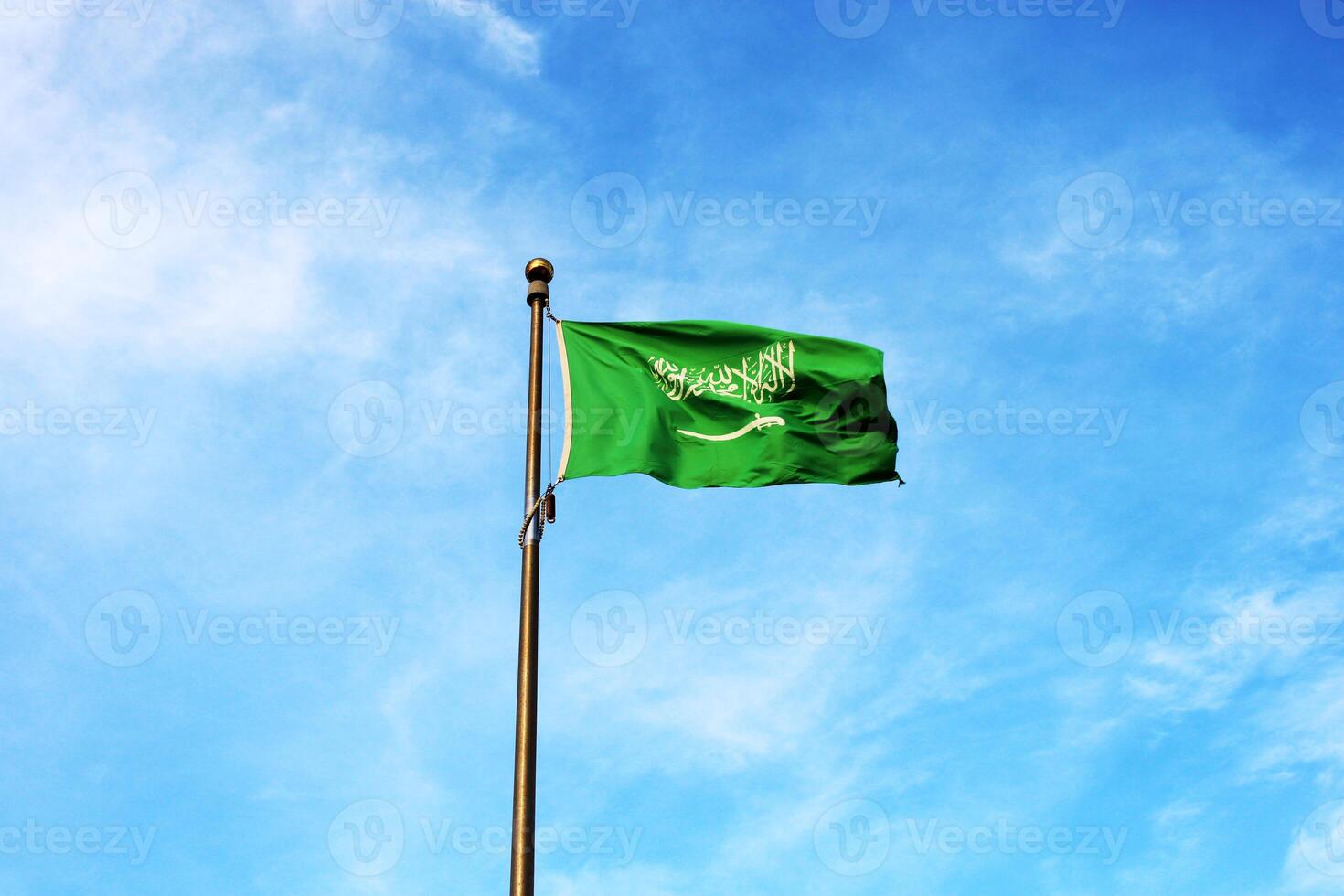 Saudi Arabia national flag waving in the sky. Islamic religion flag. photo