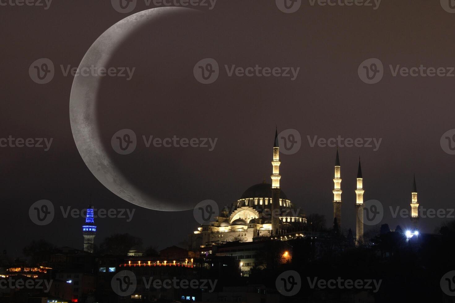 Suleymaniye mosque with a crescent moon in the background. Happy the 27th day of Ramadan or laylat al-qadr. photo