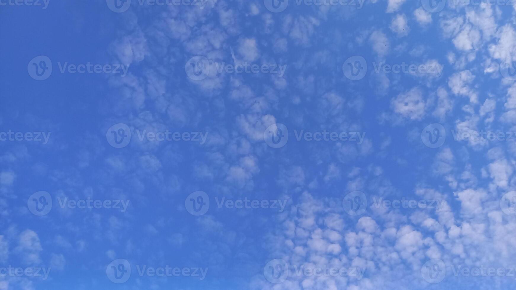 A photo of a blue sky with white clouds is suitable for the background