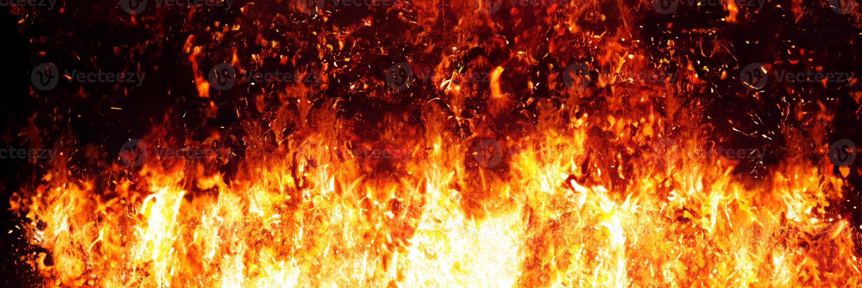 Fiery Flames Against Dark Background photo