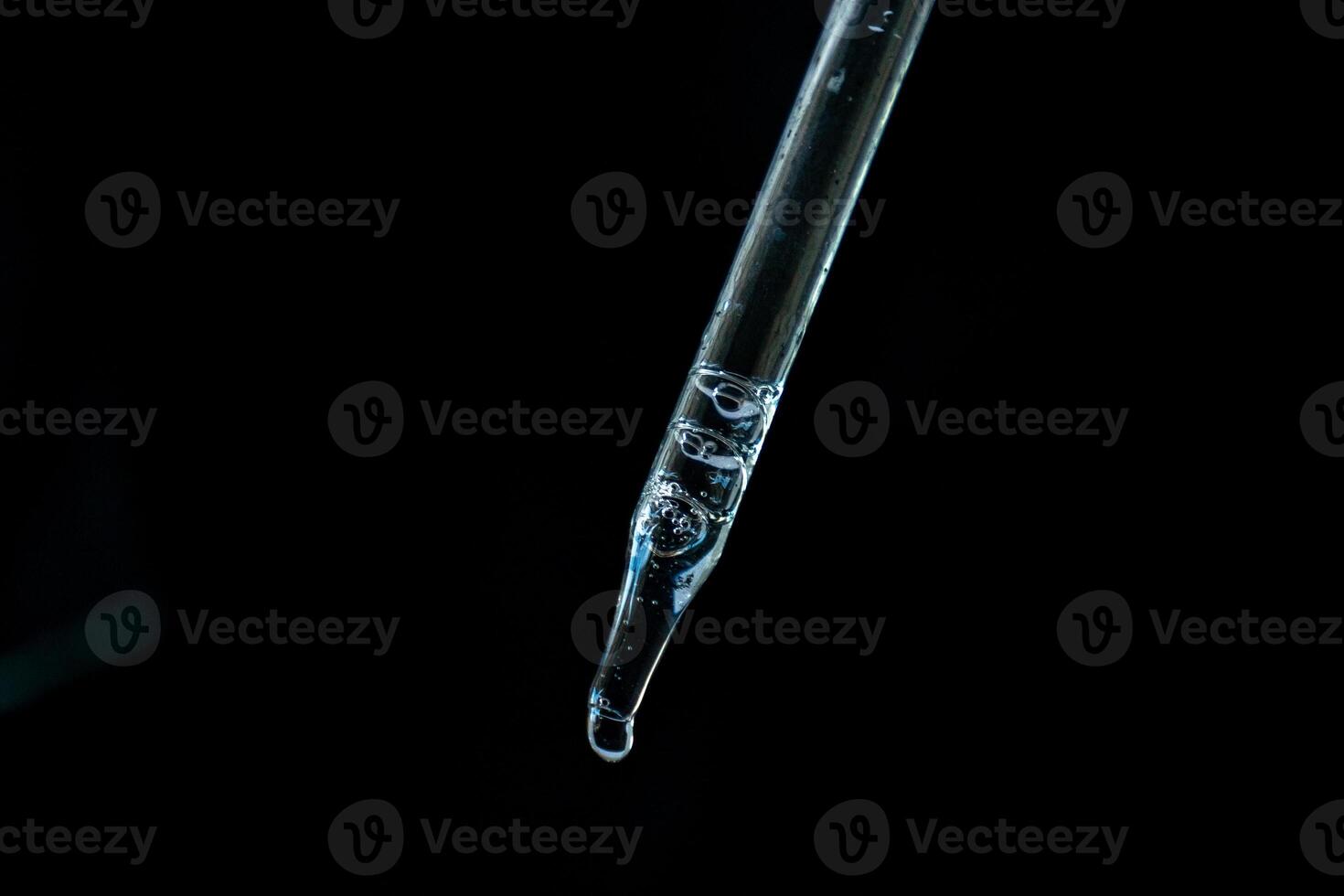 transparent pipette with clear liquid photo