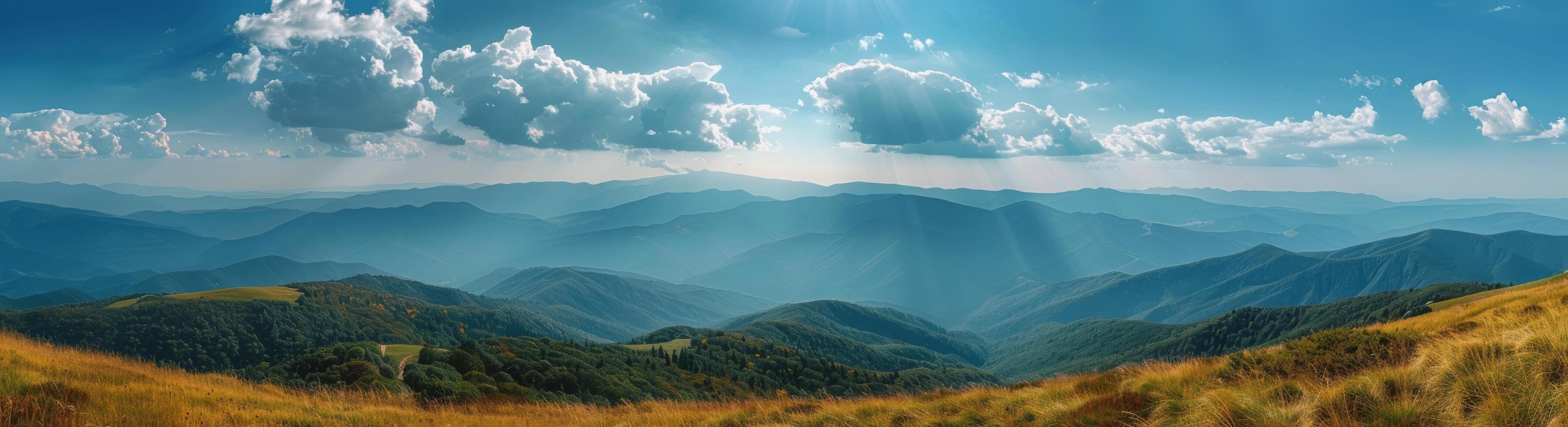 Sunny Day View Over Mountain Range With Golden Grass photo