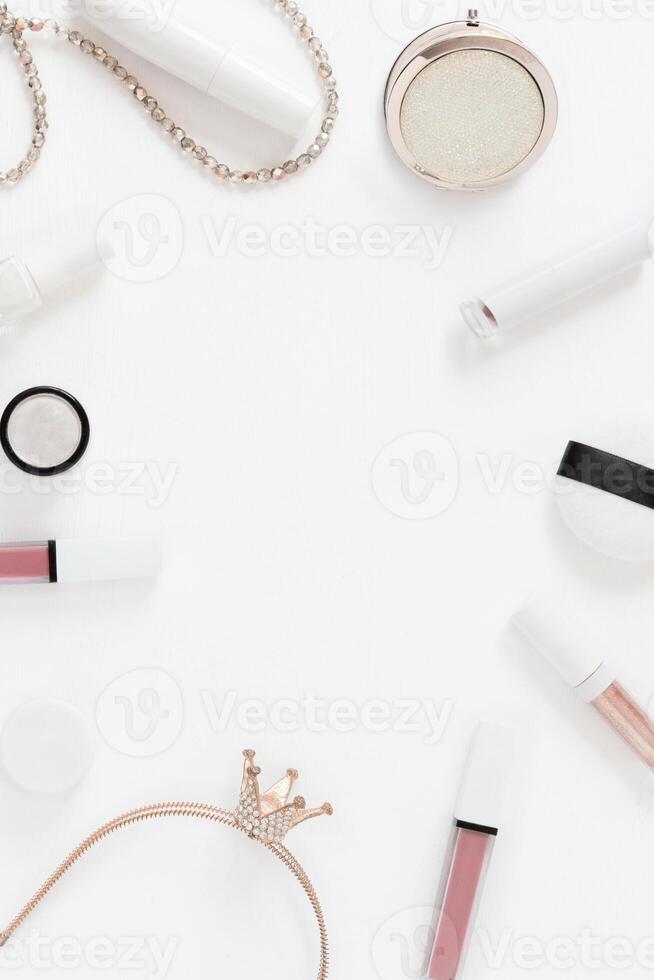 Frame background with flatley cosmetics on white. Makeup accessories lipstick mascara top view in pastel colors. Vertical template with copy space photo