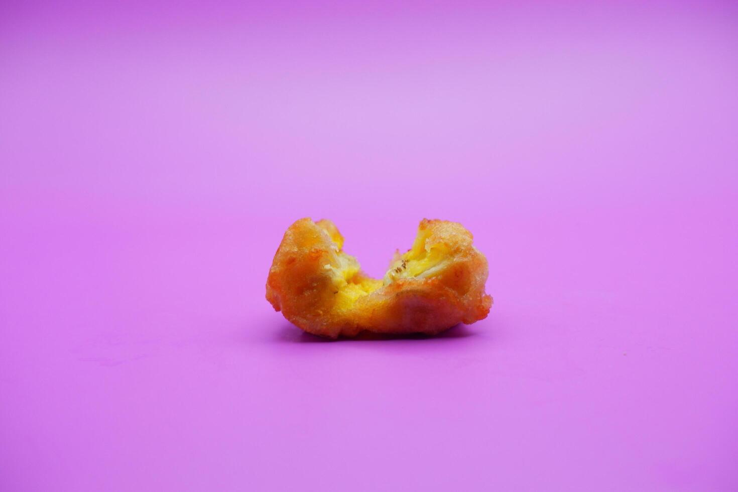 fried banana isolated on purple background. mini fried bananas photo