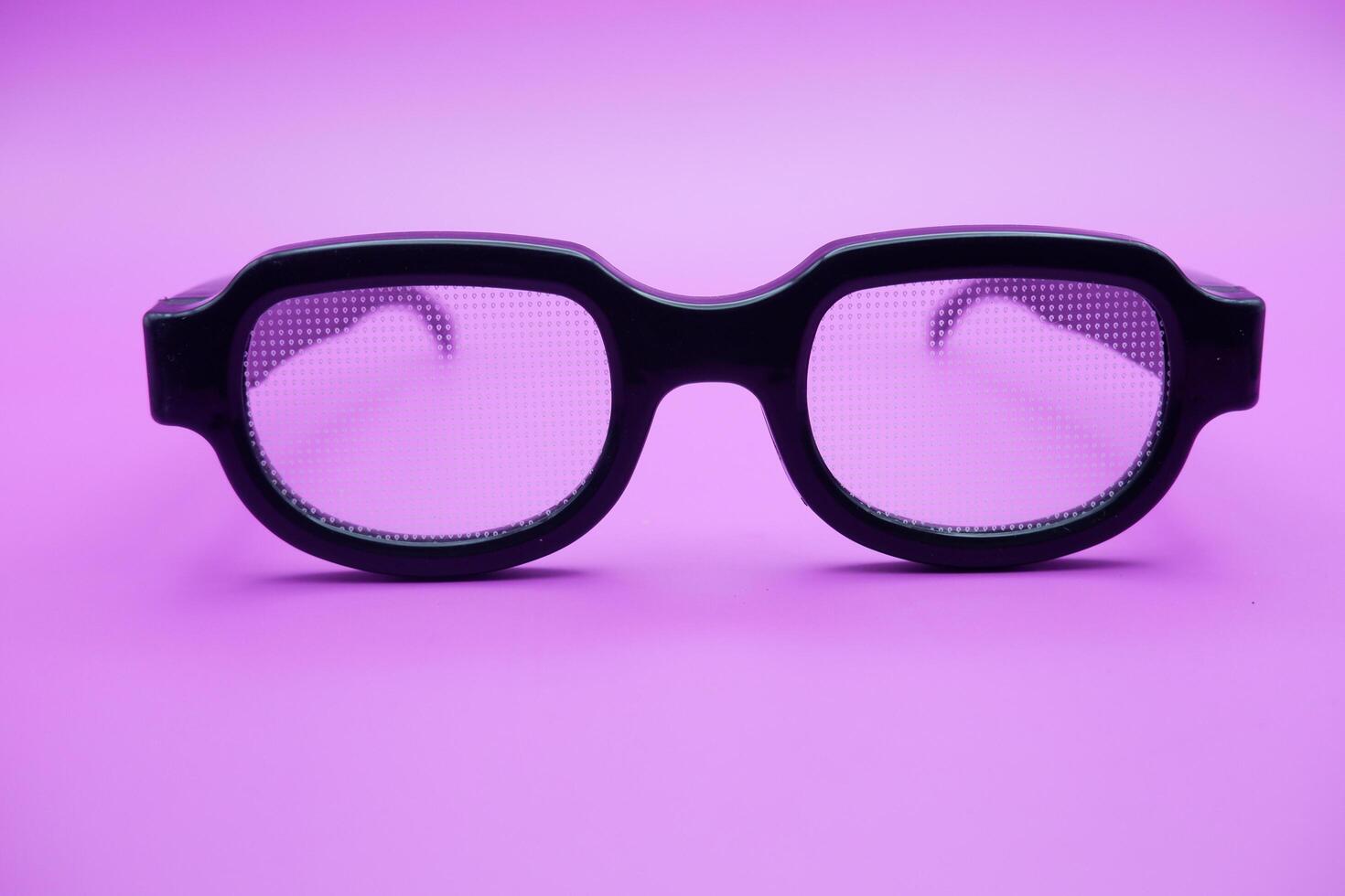 sunglasses isolated on purple background. sunglasses with curved frames and transparent glass. photo