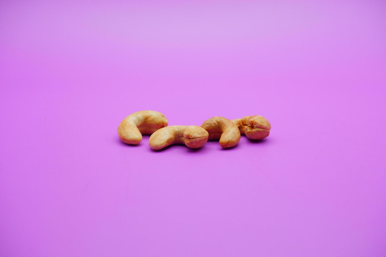 cashew nuts isolated on a purple background photo