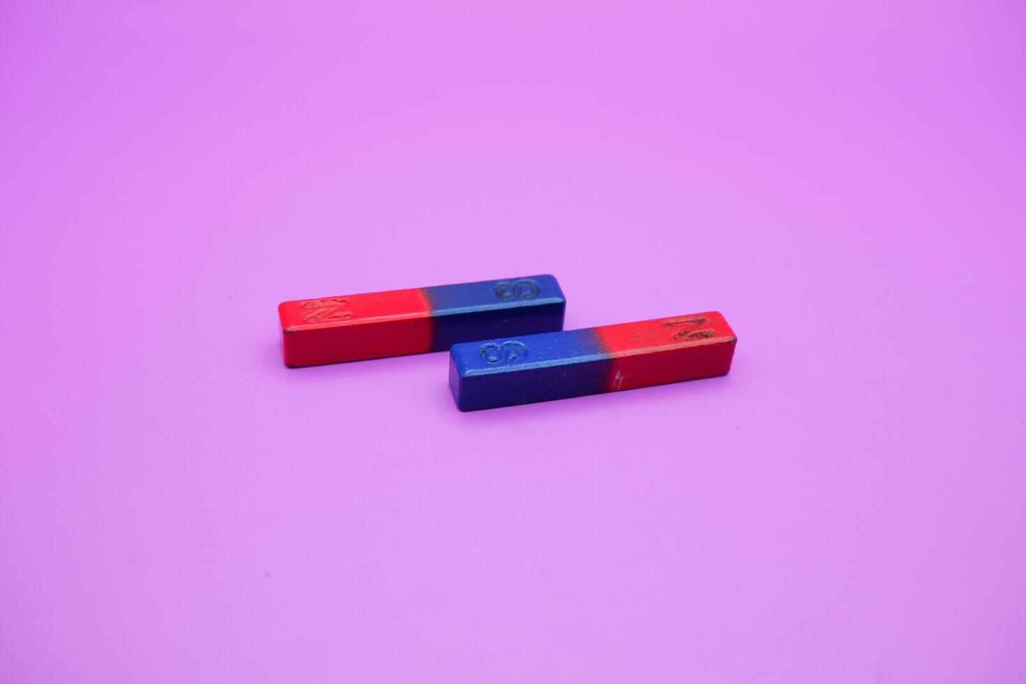 two bar magnets isolated on a purple background photo
