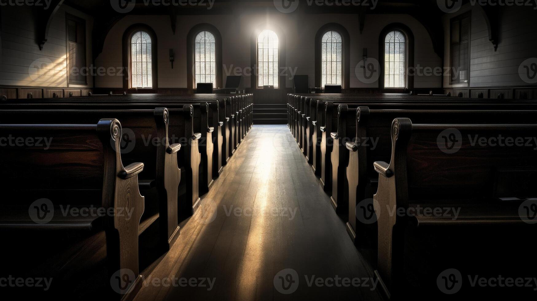 A church aisle with sunbeams streaming through the windows photo