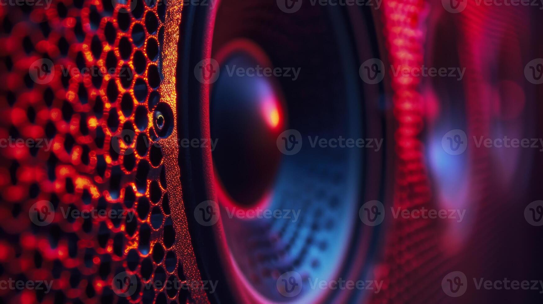Close-up shot of a speaker cone illuminated in red photo