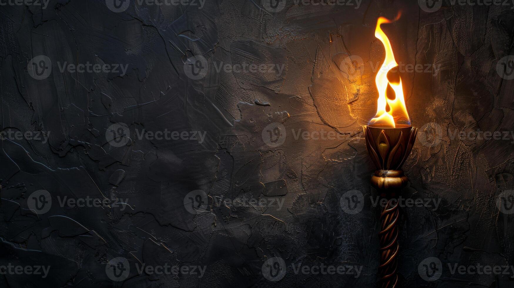 A torch burns brightly against a dark, textured wall photo