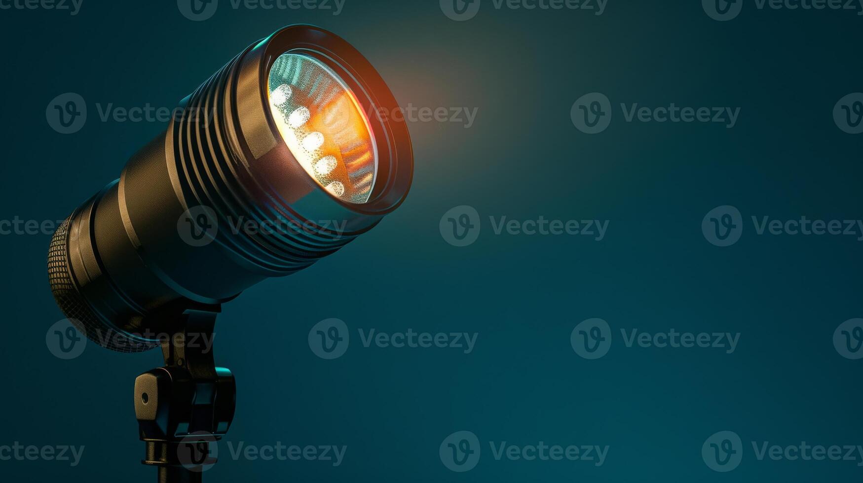 A close-up shot of a black spotlight on a teal backdrop photo