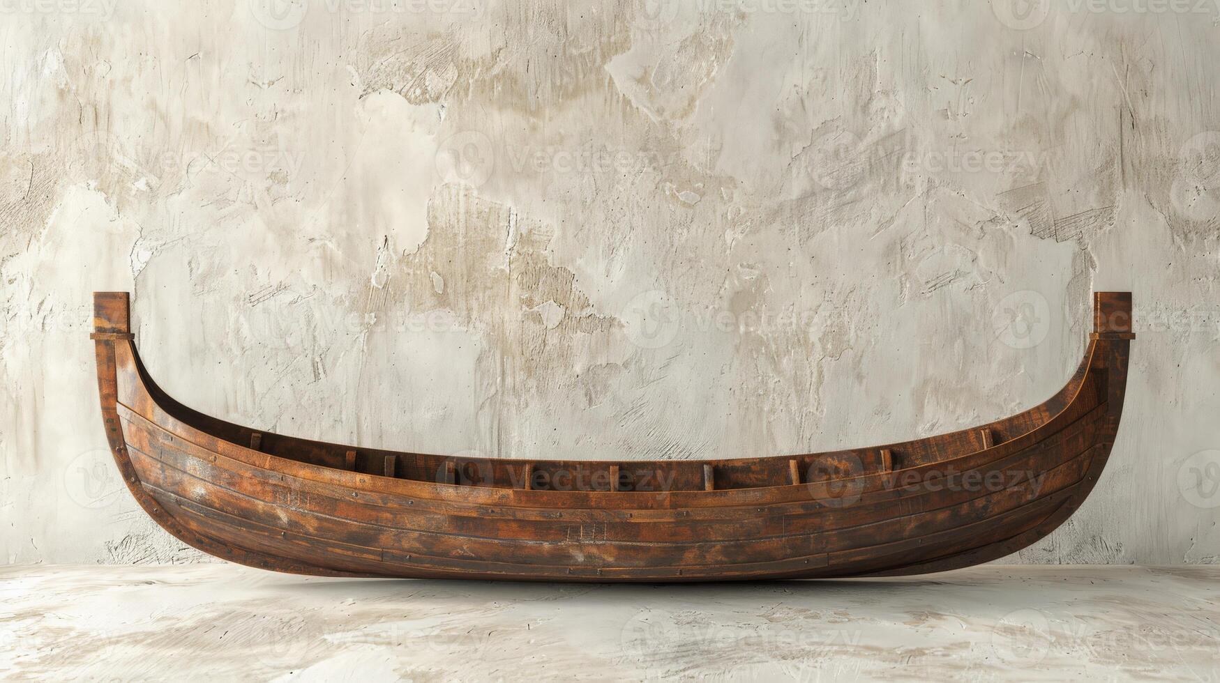 A wooden rowboat sits empty against a textured concrete wall photo