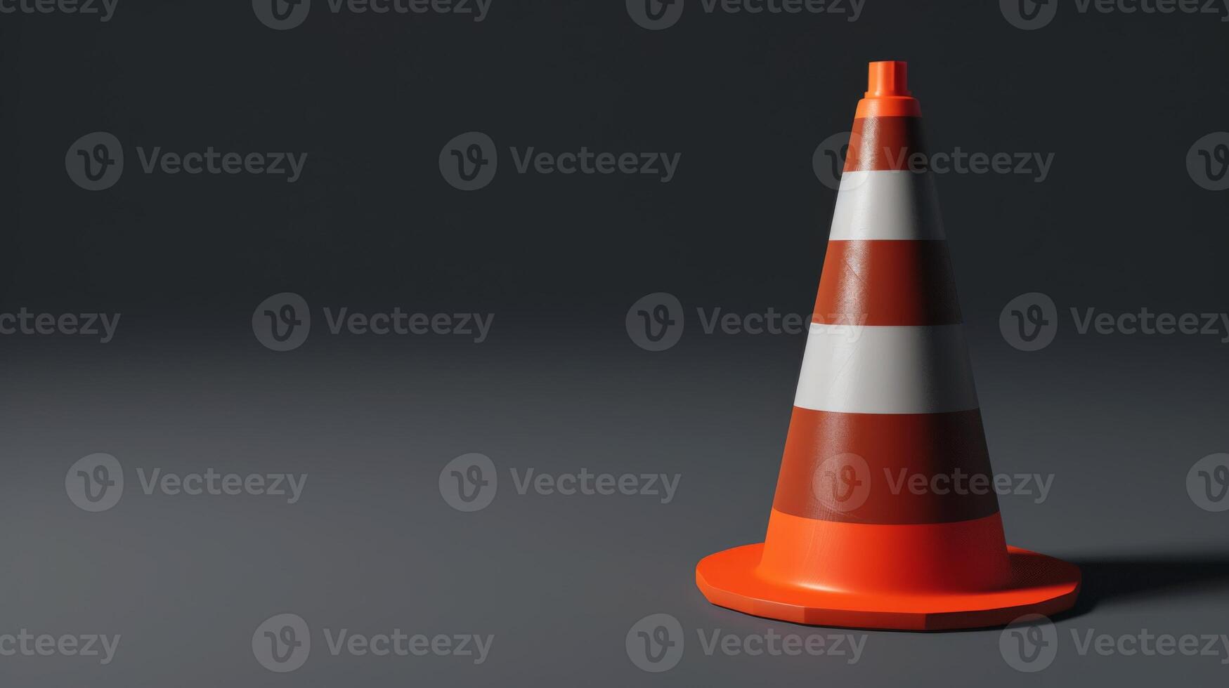 A traffic cone on a dark grey background photo