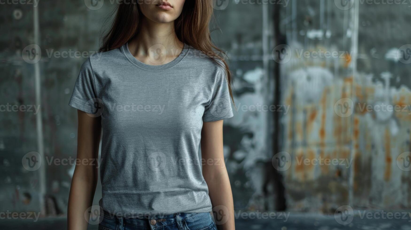 A woman model wears a blank t-shirt with space for text against a distressed concrete wall photo