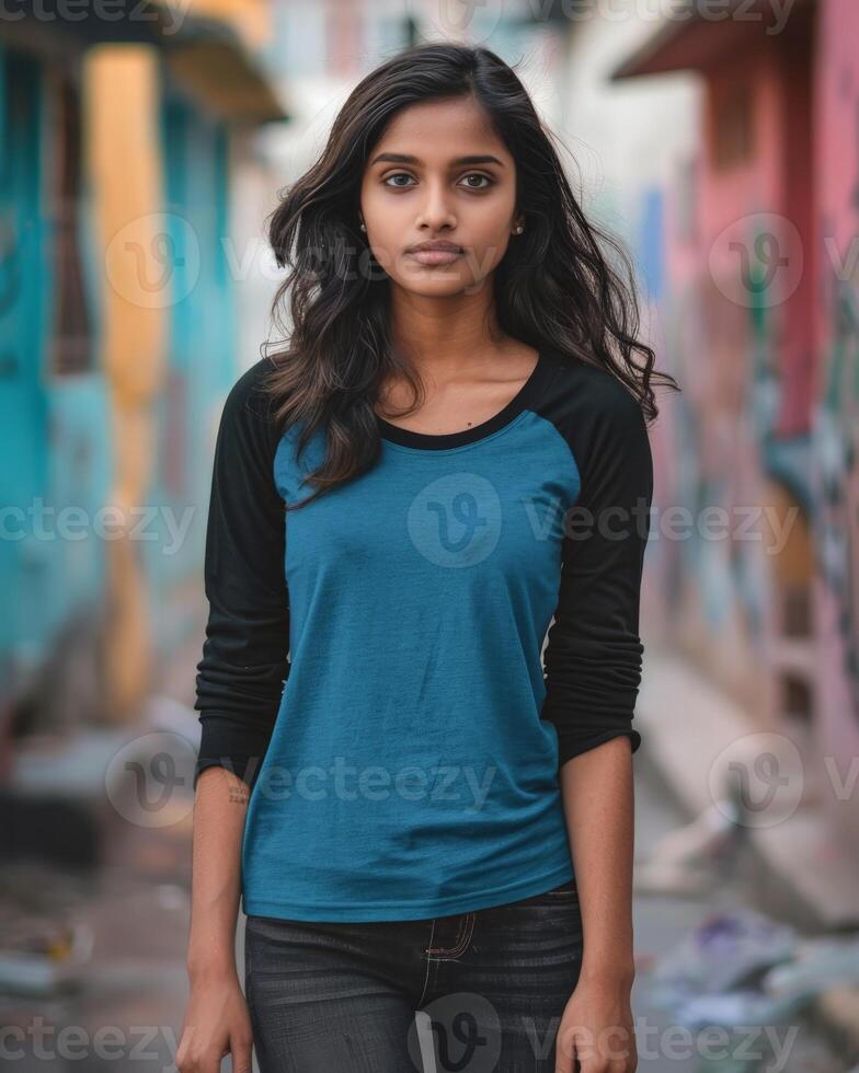 A young woman wearing a blue raglan shirt walks confidently through a colorful alleyway photo