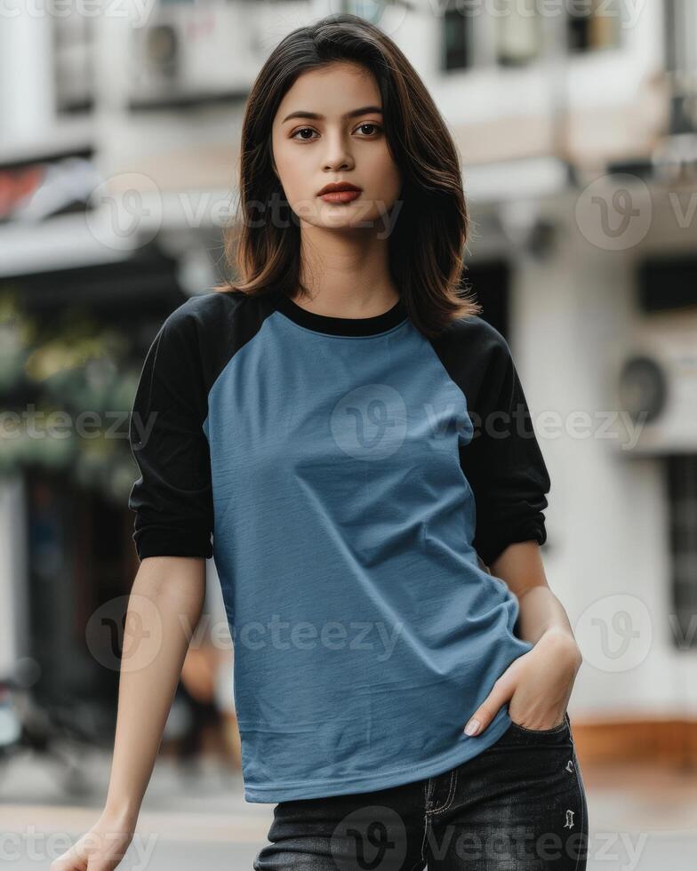 Woman wearing a blue raglan tee with black sleeves photo