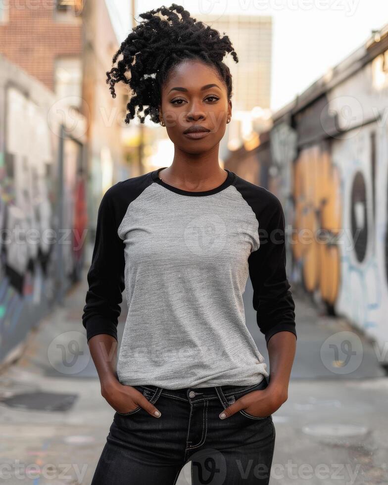 A woman in a raglan shirt stands in an alleyway photo