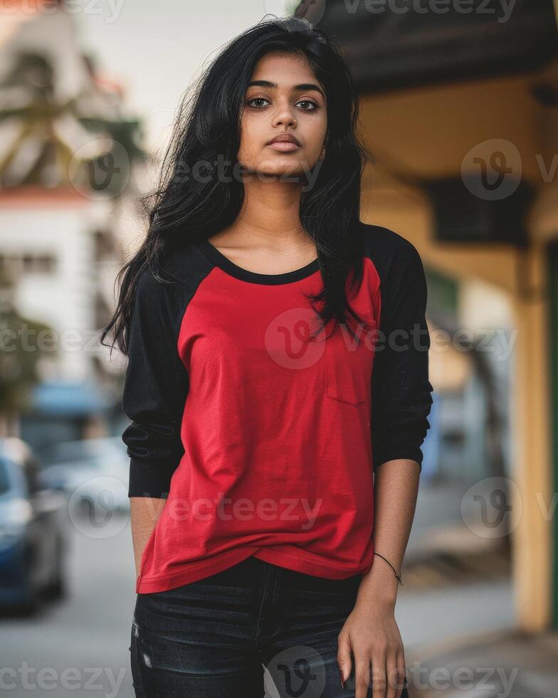 A woman wears a red and black raglan shirt photo