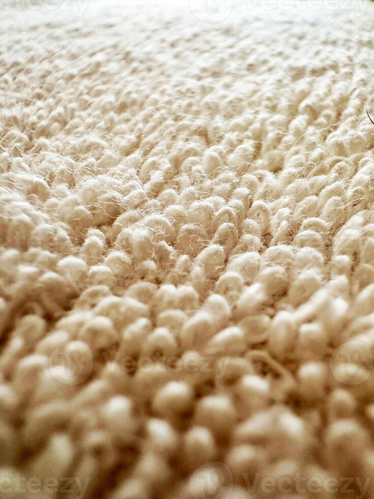 Closeup view of a pastel colored towel. Soft background pattern, White Rug. Carpet knitting photo