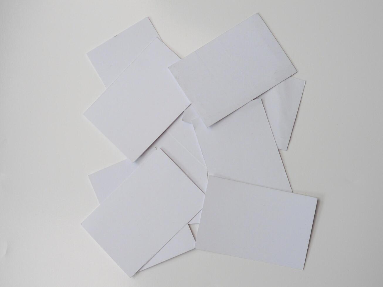 Pile of blank pieces of paper scattered around on white background photo