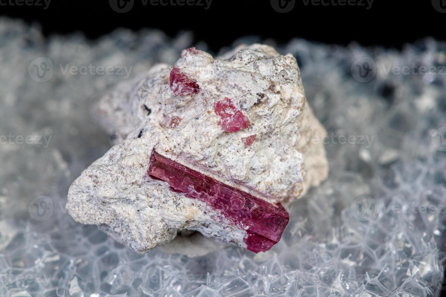 macro mineral stone red beryl on a black background photo