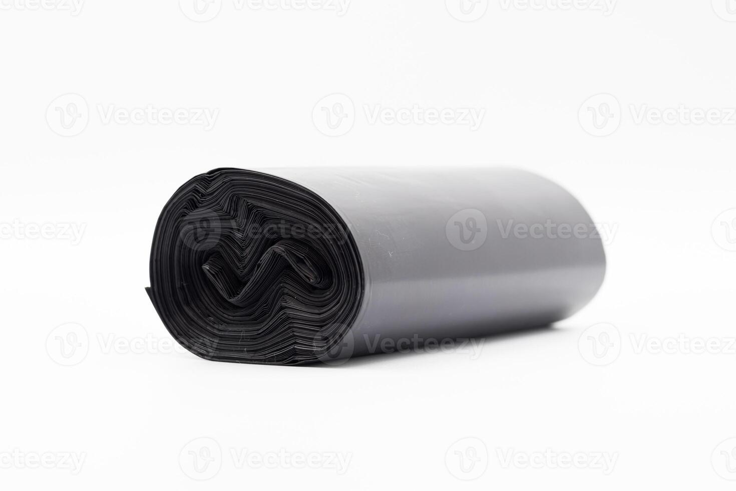 Black plastic garbage bags on white background, Roll of garbage bags on white background photo