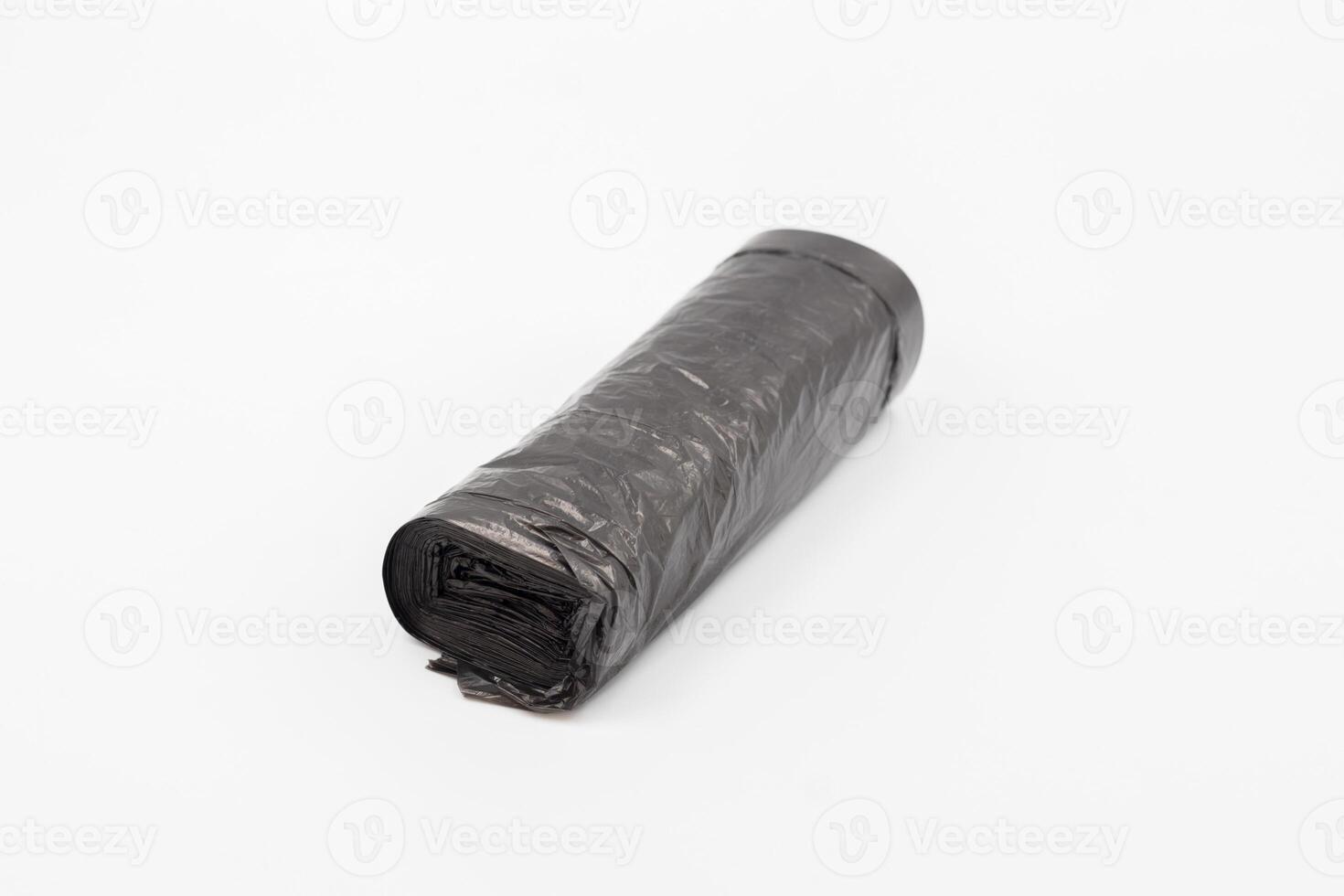 Black plastic garbage bags on white background, Roll of garbage bags on white background photo