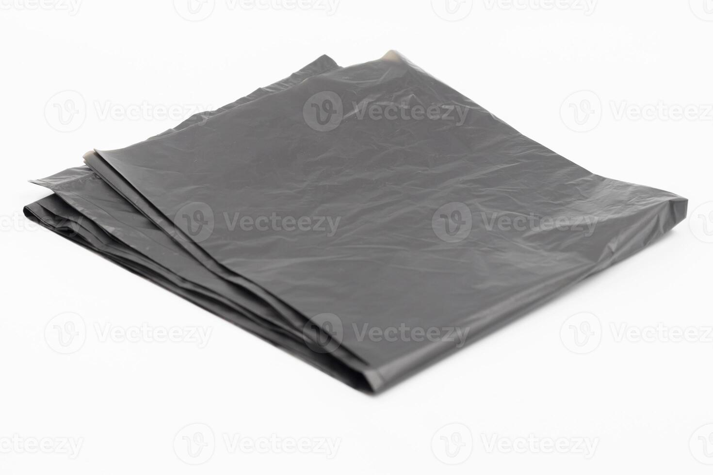 Black plastic garbage bags on white background, Roll of garbage bags on white background photo
