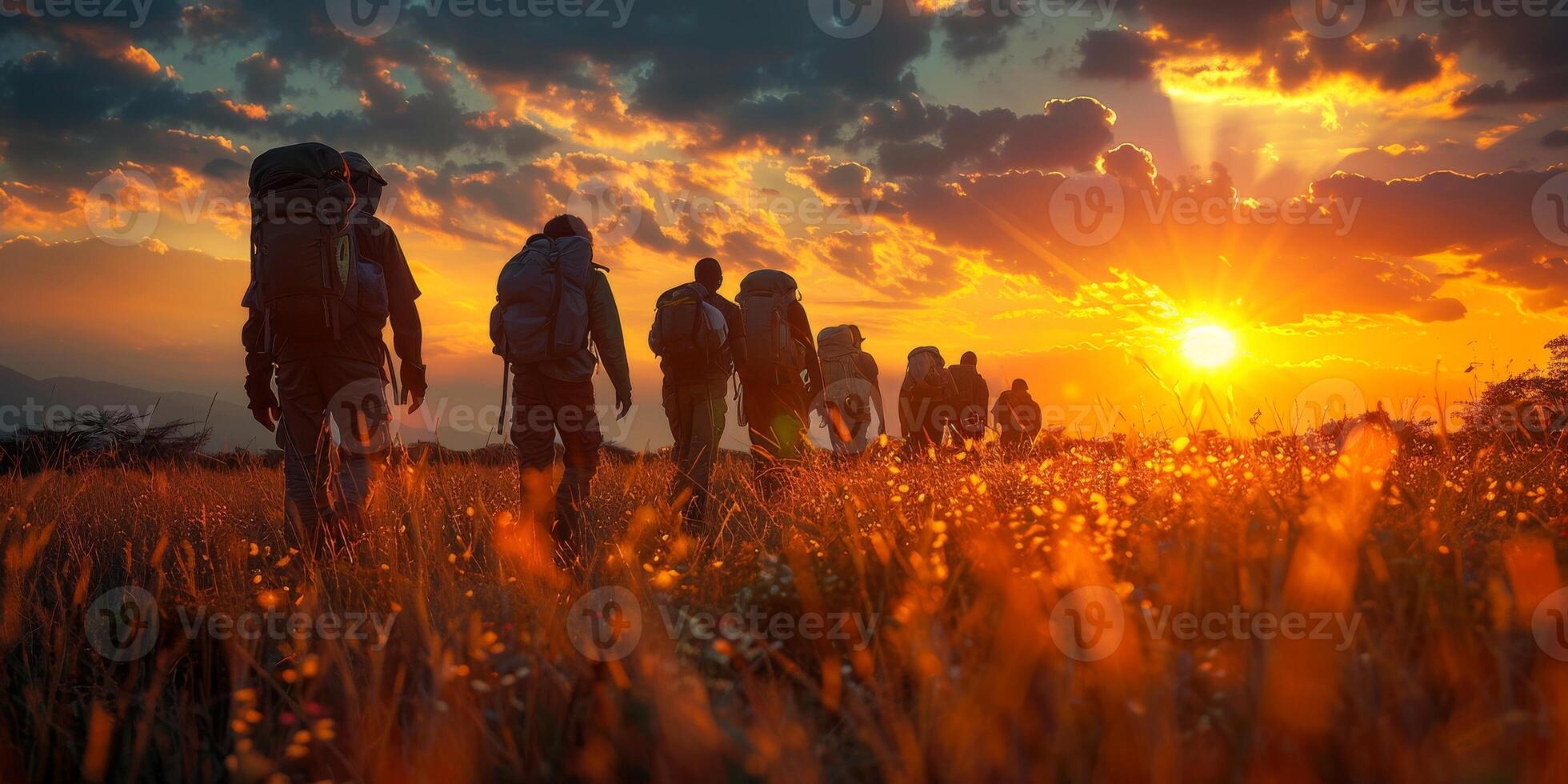 As the sun sets, a military unit is strolling across a meadow photo