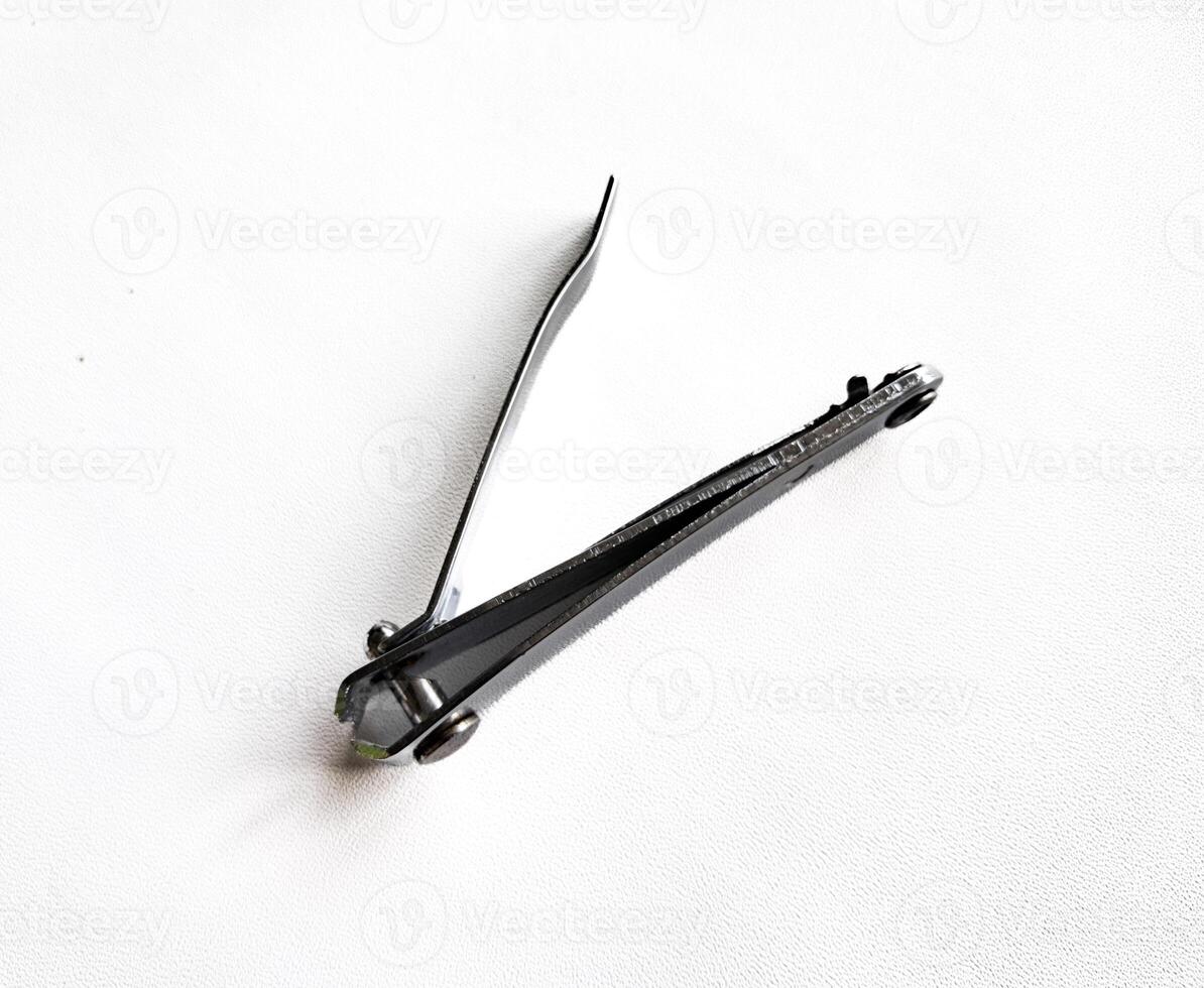 Cut nail clippers metal. Isolated on white background photo