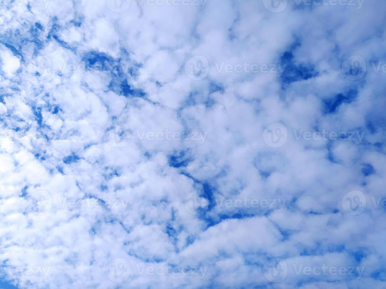 Clear blue sky texture and white fluffy cloud nature background. The sun shines bright in the daytime in summer photo