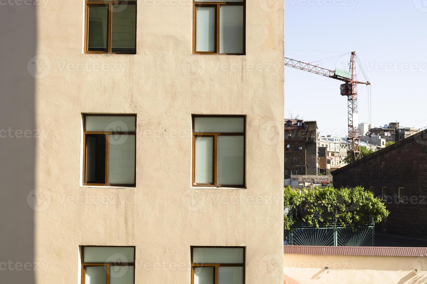 wall of apartment house and construction crane photo